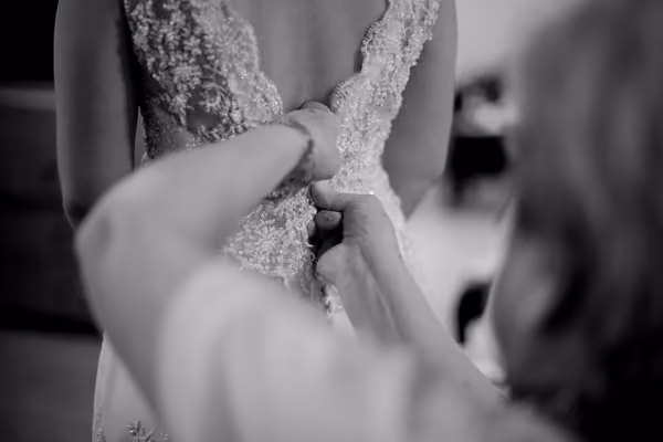 Fastening the back of a dress during a fitting