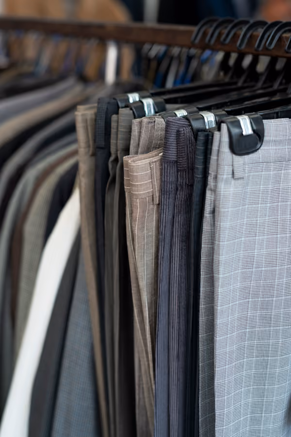 Altered pants and trousers hanging on a rack